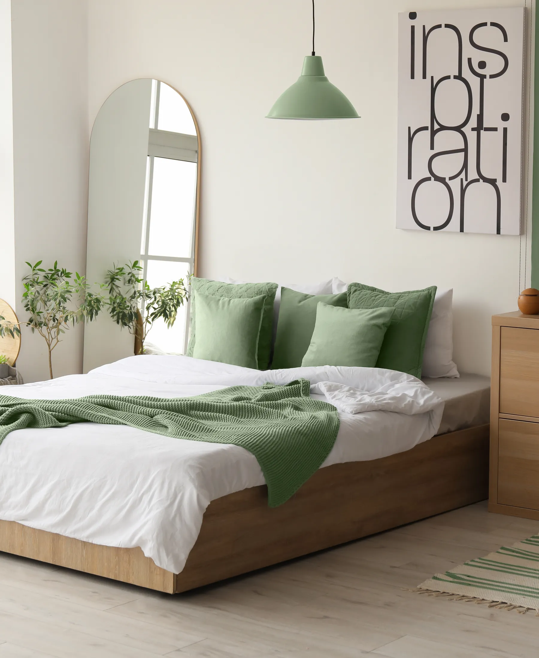A calm, contemporary bedroom with softly layered neutral bedding